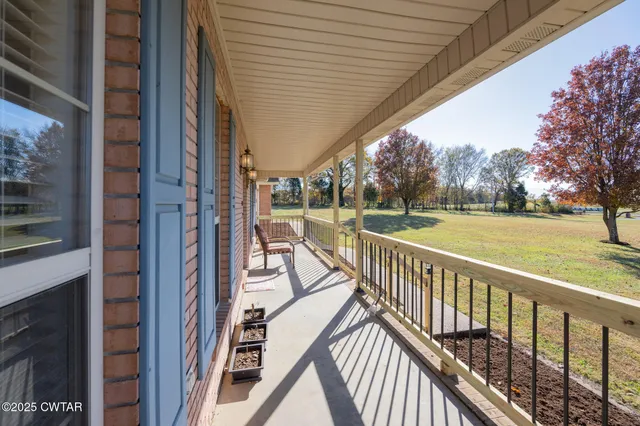 a balcony with wooden floor and outdoor seating