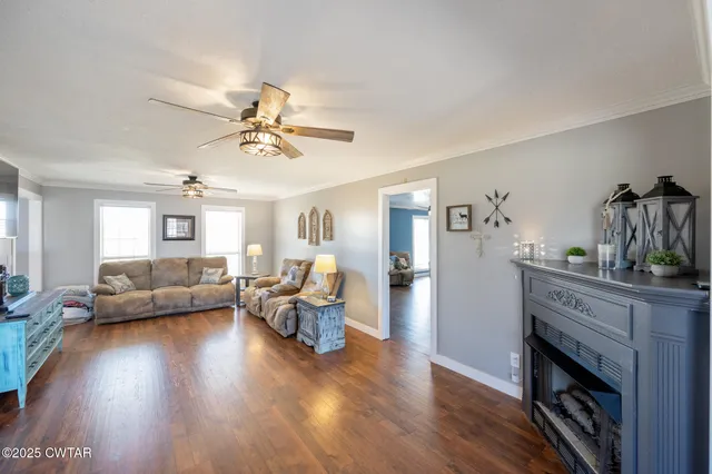a living room with furniture and a wooden floor