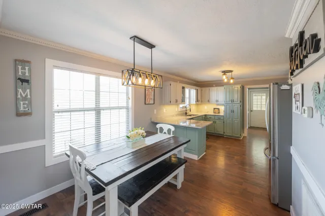 a dining room with furniture a chandelier and wooden floor
