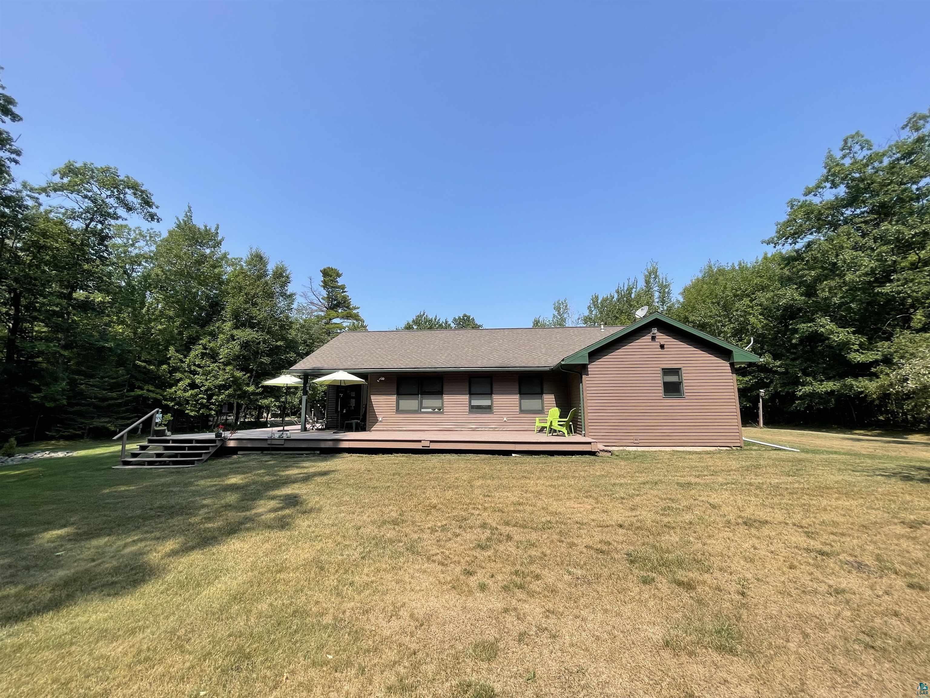 84830 Old San Road Bayfield, WI 54814 - Photo 2 of 30 North side of the home, with large deck overlooking the back yard, fenced flower garden, and shed.