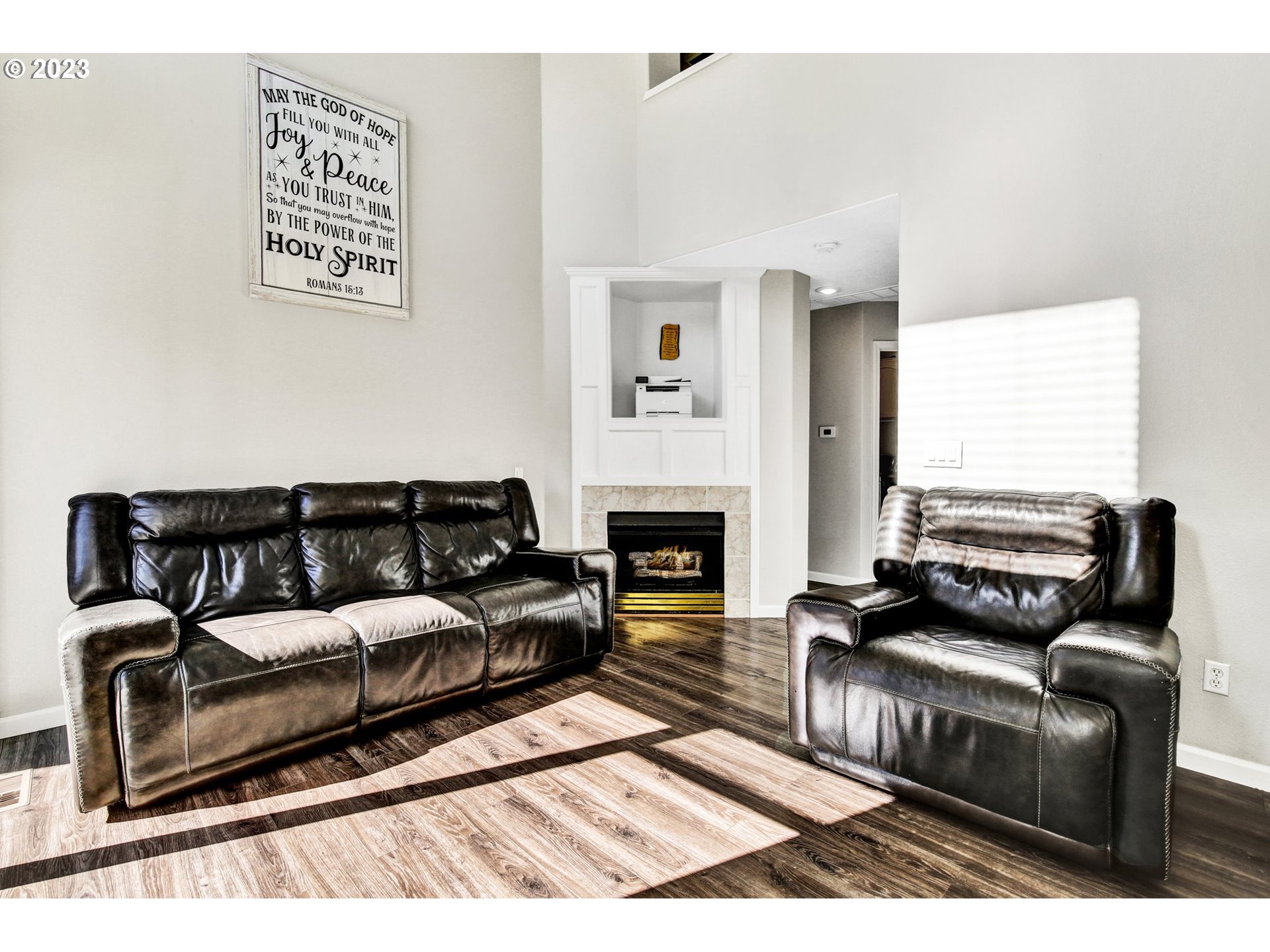 16128 Southeast Rural Court Portland, OR 97236 - Photo 15 of 37 a living room with furniture and a fireplace