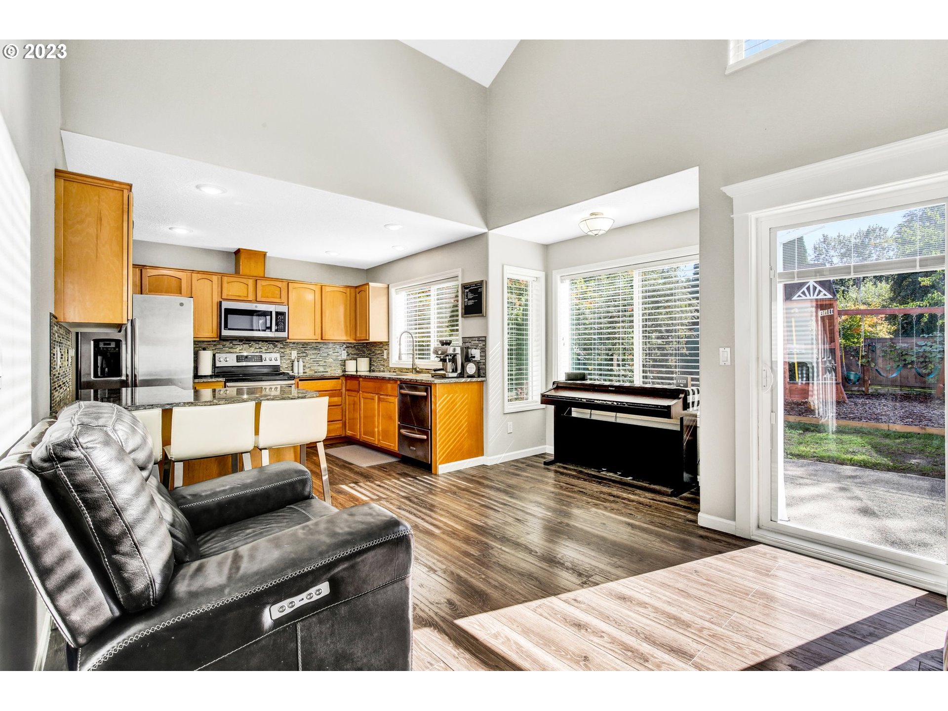 16128 Southeast Rural Court Portland, OR 97236 - Photo 16 of 37 a living room with stainless steel appliances furniture stove and kitchen view