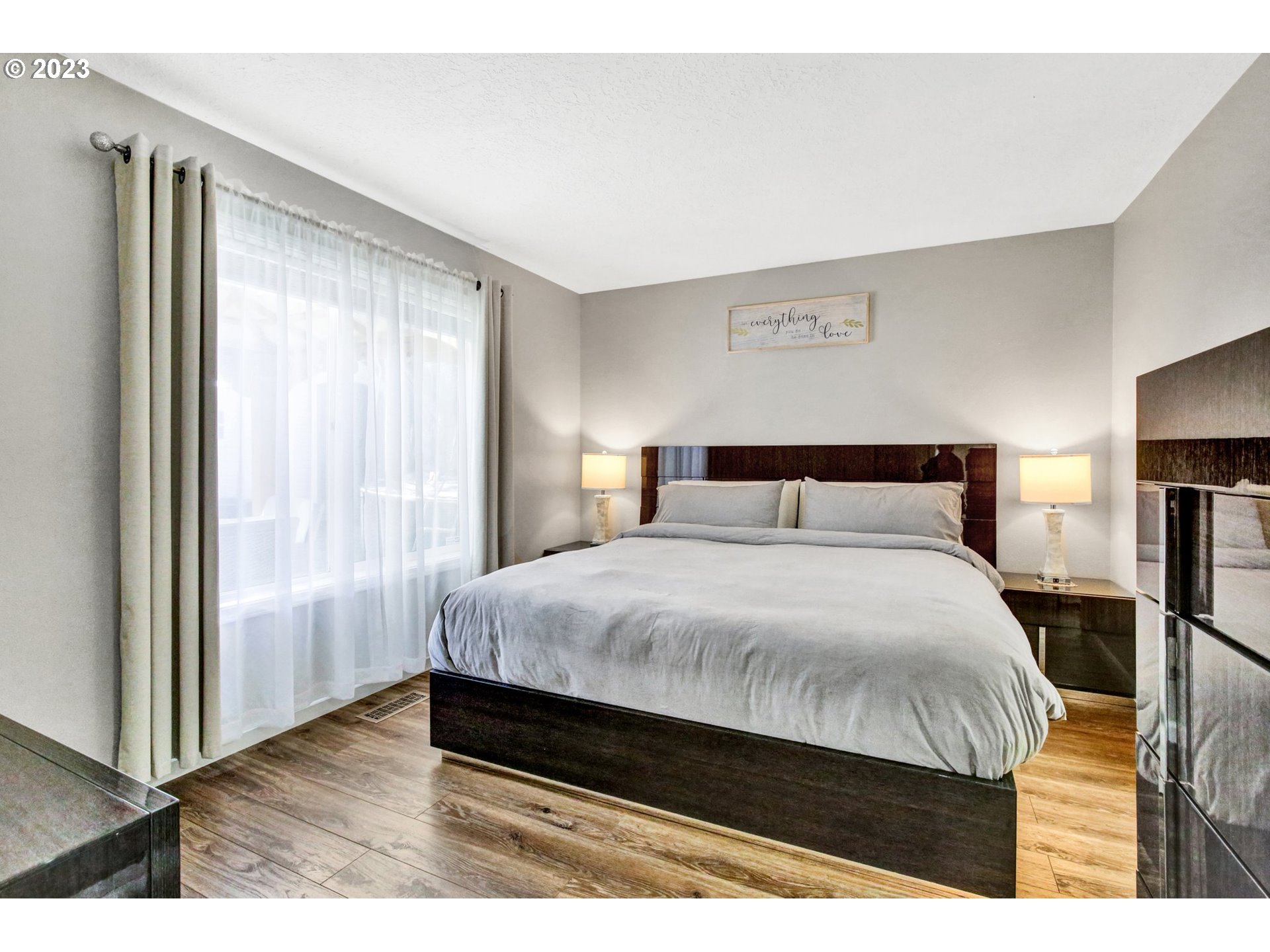 16128 Southeast Rural Court Portland, OR 97236 - Photo 17 of 37 a bedroom with a bed and wooden floor