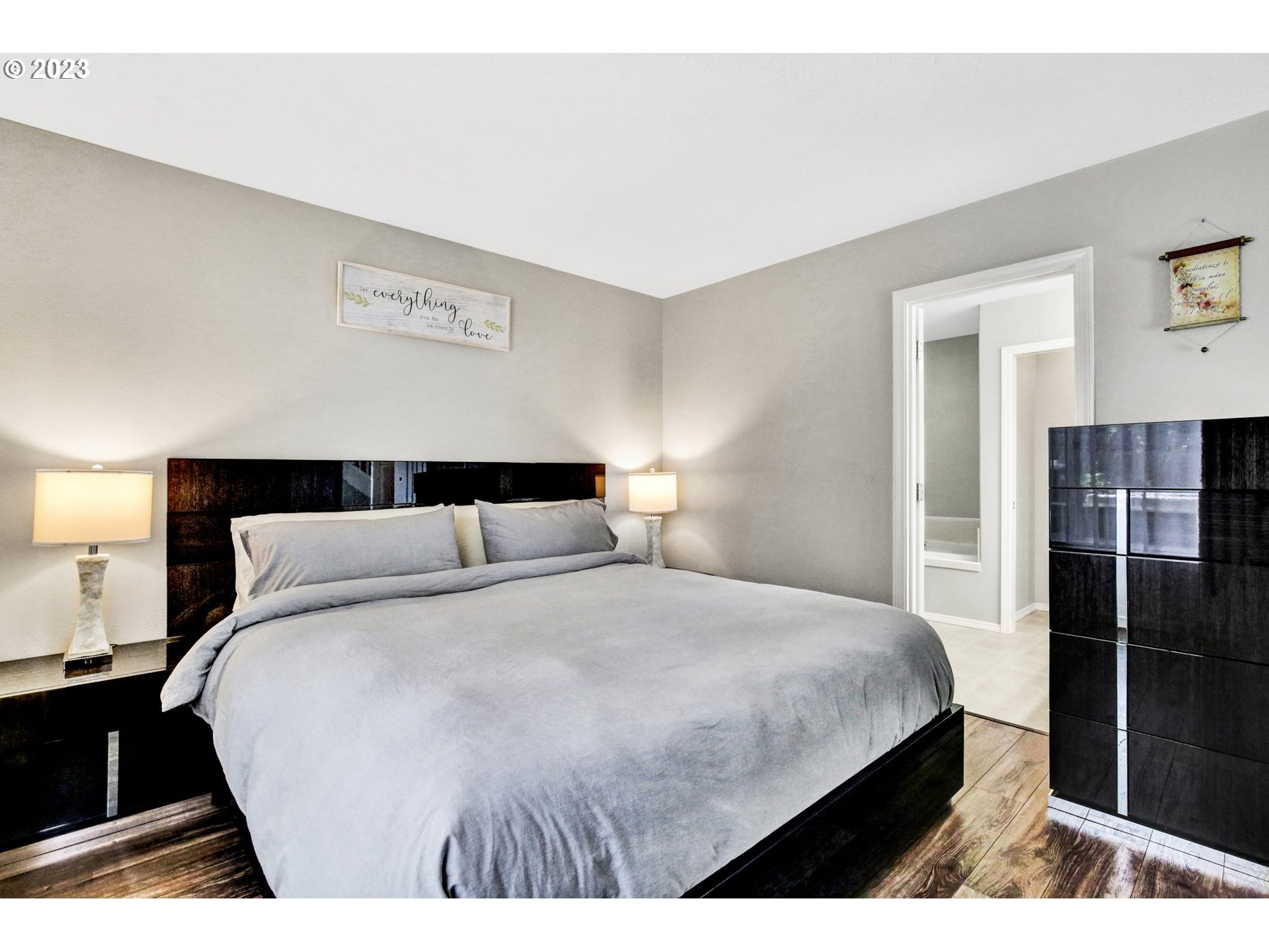 16128 Southeast Rural Court Portland, OR 97236 - Photo 18 of 37 a bedroom with a bed and a night stand