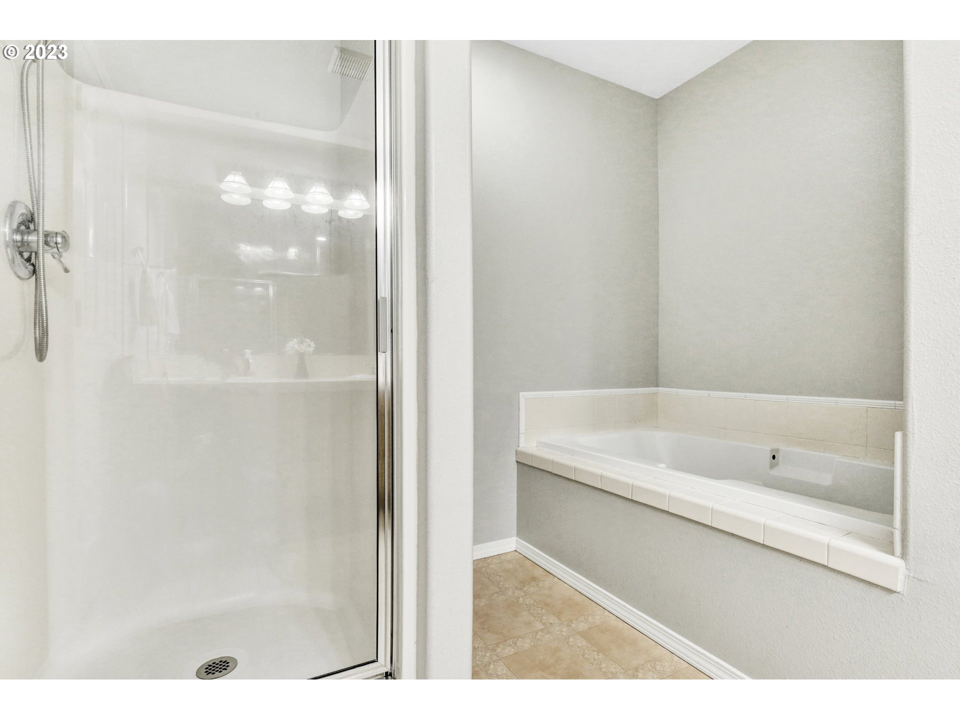 16128 Southeast Rural Court Portland, OR 97236 - Photo 21 of 37 a bathroom with a bathtub and a shower