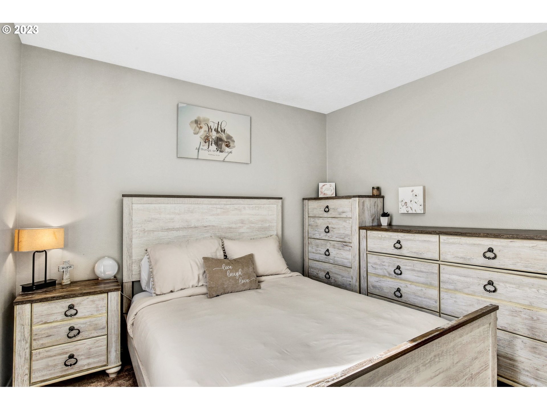 16128 Southeast Rural Court Portland, OR 97236 - Photo 26 of 37 a bedroom with a bed and lamp