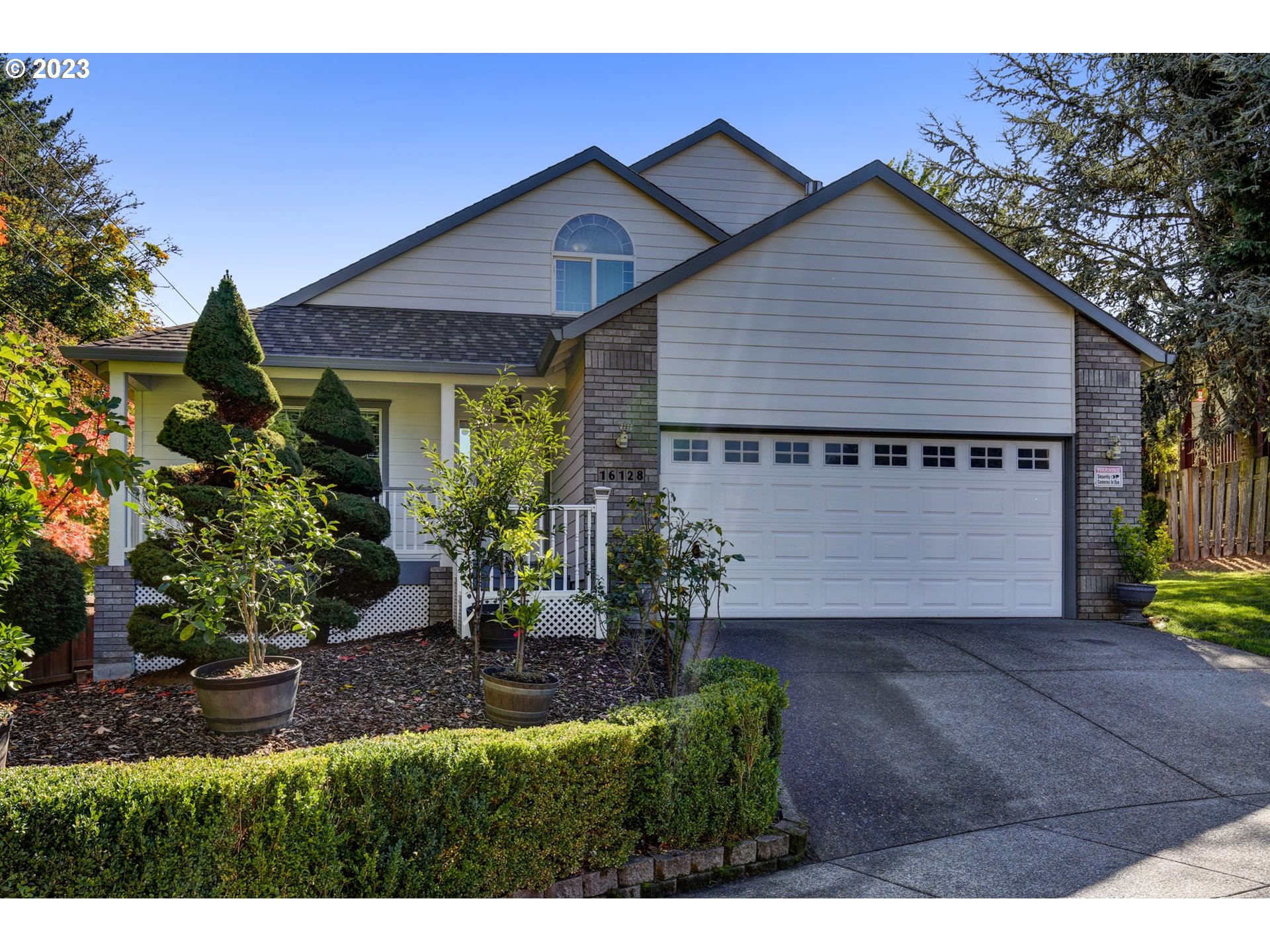 16128 Southeast Rural Court Portland, OR 97236 - Photo 3 of 37 a view of a house with a yard and potted plants