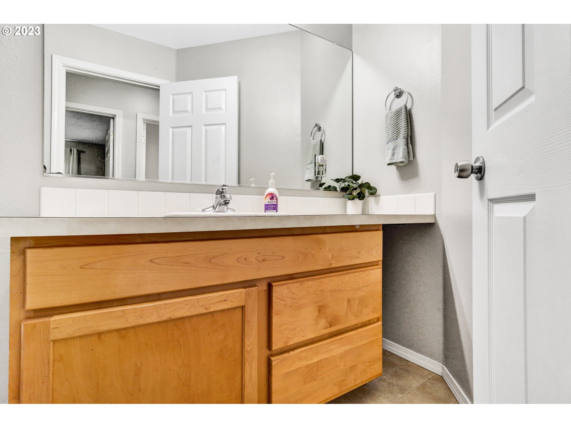 16128 Southeast Rural Court Portland, OR 97236 - Photo 31 of 37 a bathroom with a sink and a mirror