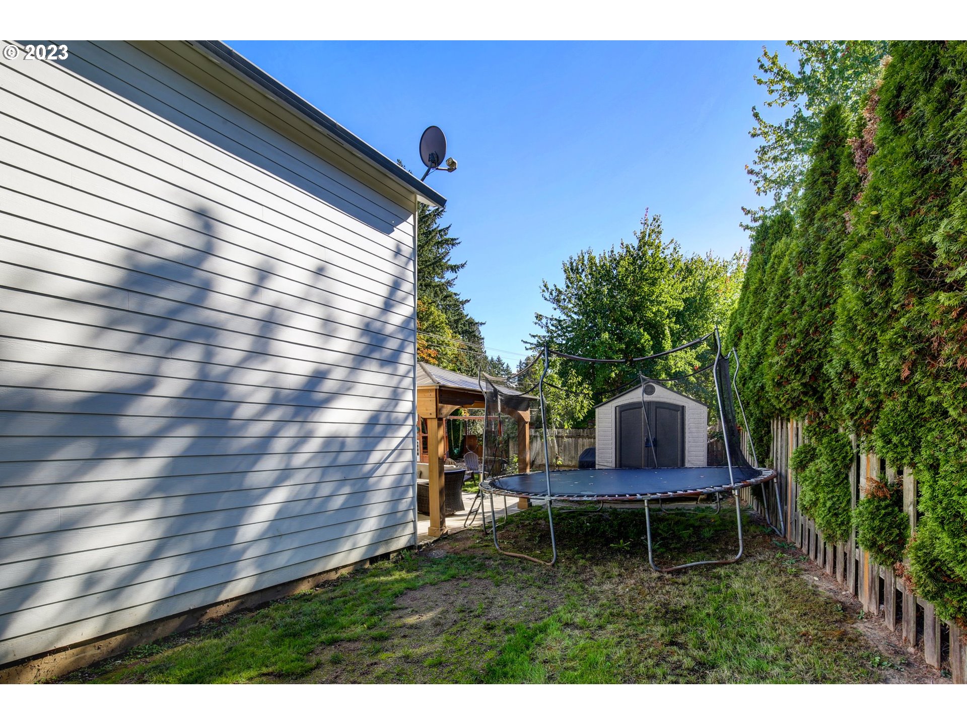 16128 Southeast Rural Court Portland, OR 97236 - Photo 36 of 37 a backyard of a house with table and chairs
