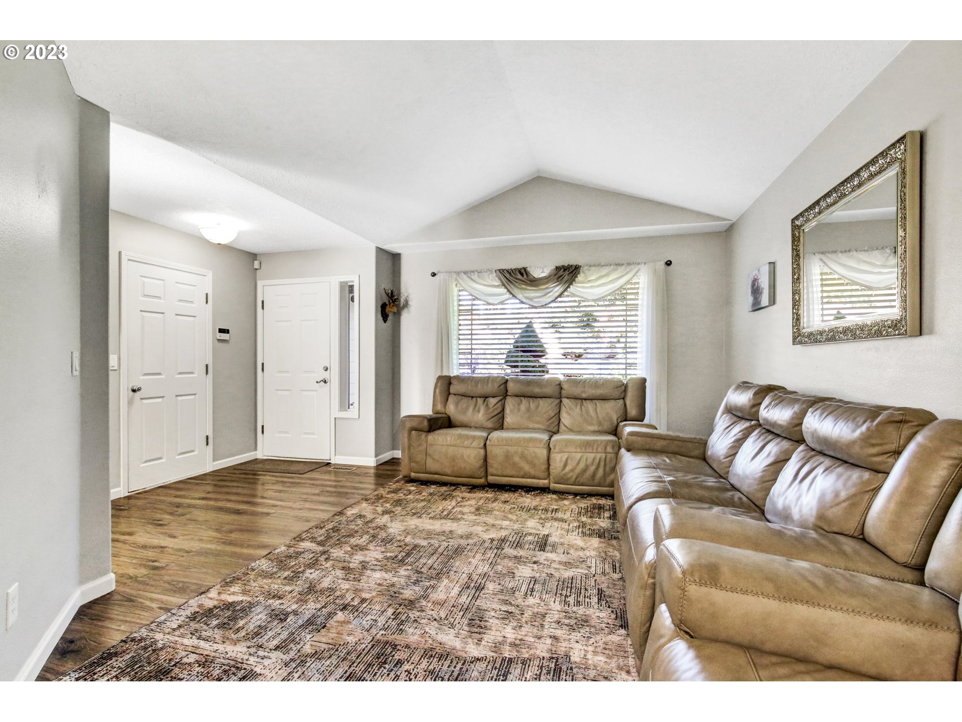 16128 Southeast Rural Court Portland, OR 97236 - Photo 7 of 37 a living room with furniture and a large window
