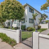 a front view of a house with a yard and fountain