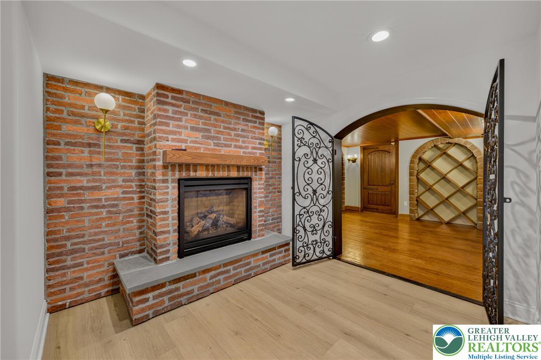3130 Muirfield Road Center Valley, PA 18034 - Photo 50 of 63 A classic brick fireplace anchors this inviting space, leading directly into a custom wine cellar.