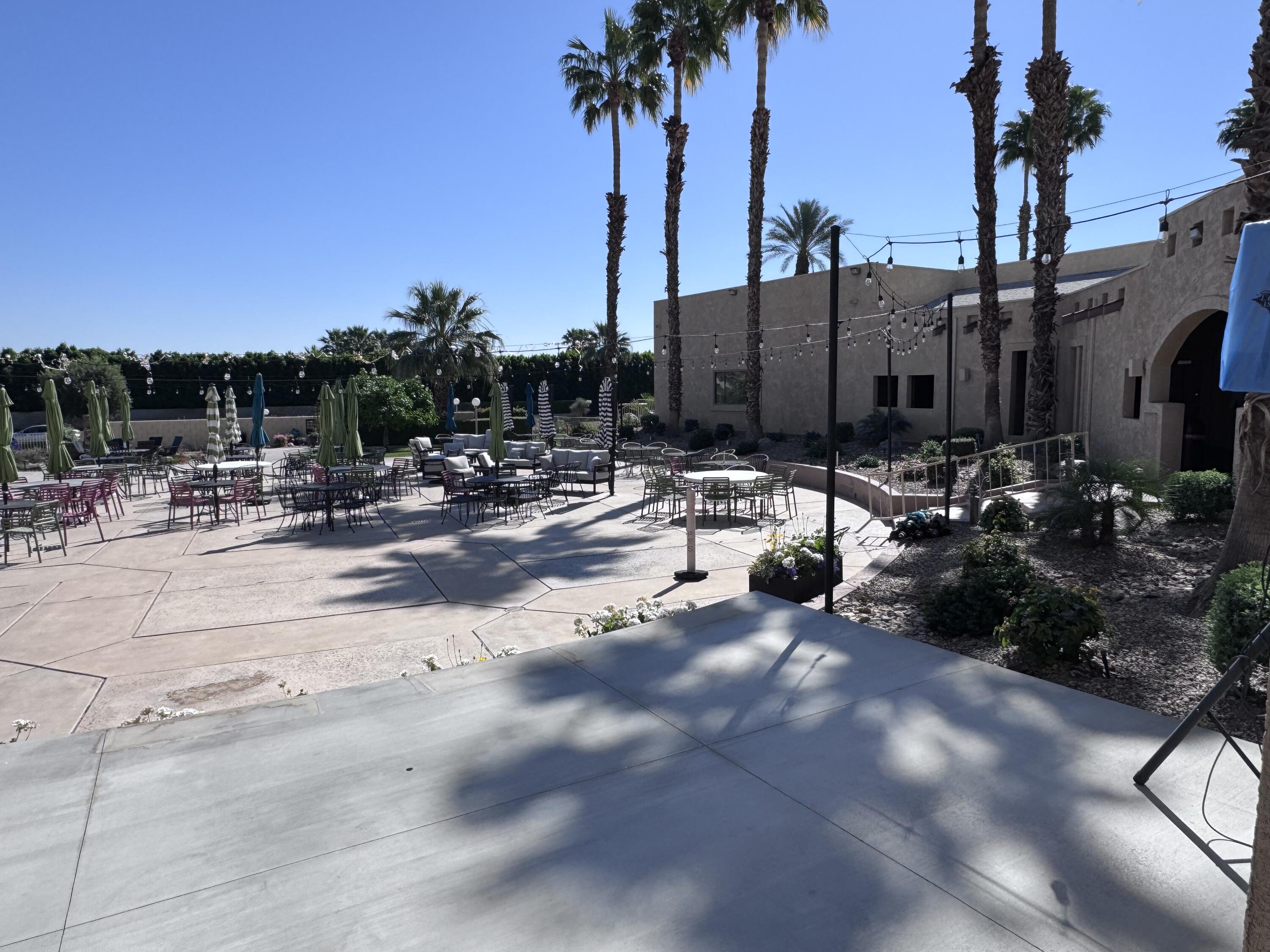 81620 Ave 49, Unit 160B Indio, CA 92201 - Photo 14 of 18 a view of a patio with a table and chairs under an umbrella