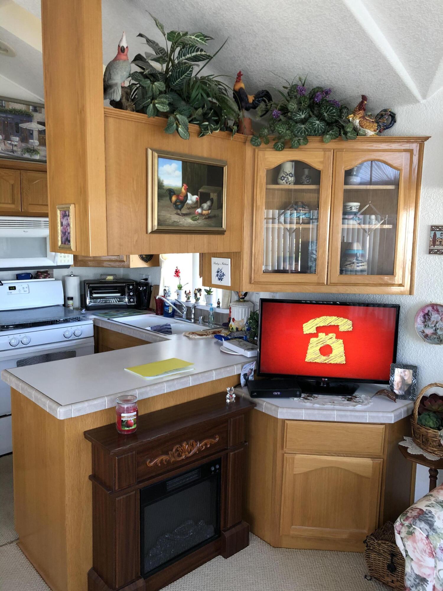 81620 Ave 49, Unit 160B Indio, CA 92201 - Photo 3 of 18 a kitchen with stainless steel appliances granite countertop a stove a sink and a microwave