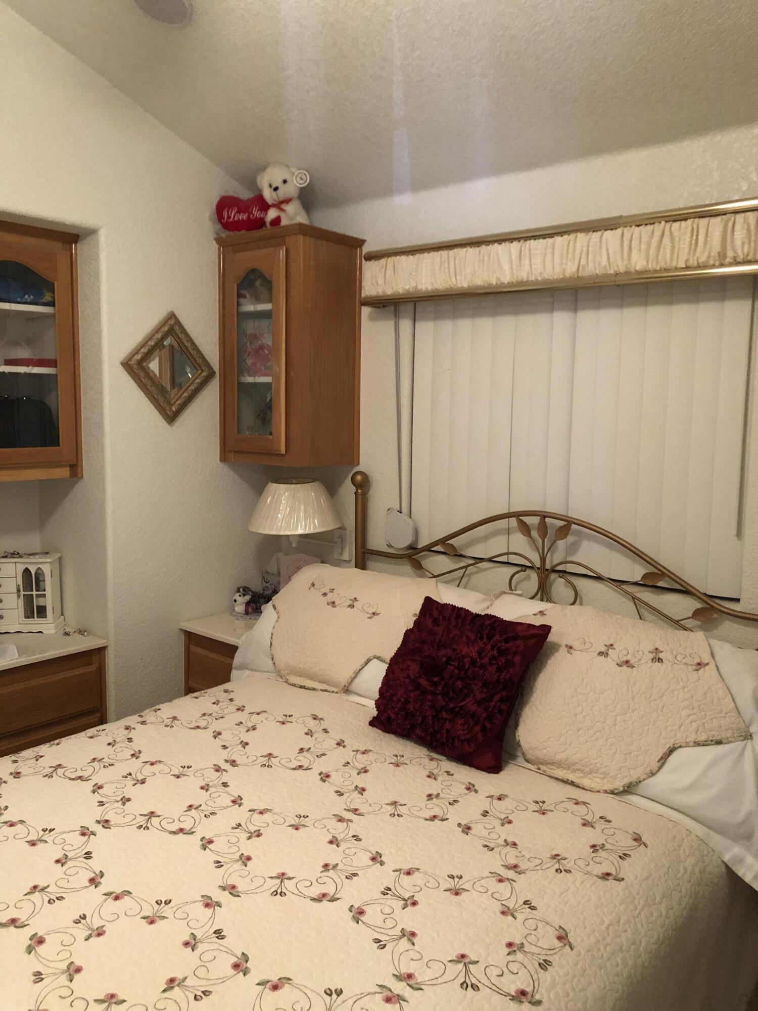 81620 Ave 49, Unit 160B Indio, CA 92201 - Photo 7 of 18 a bedroom with a bed and dresser with mirror