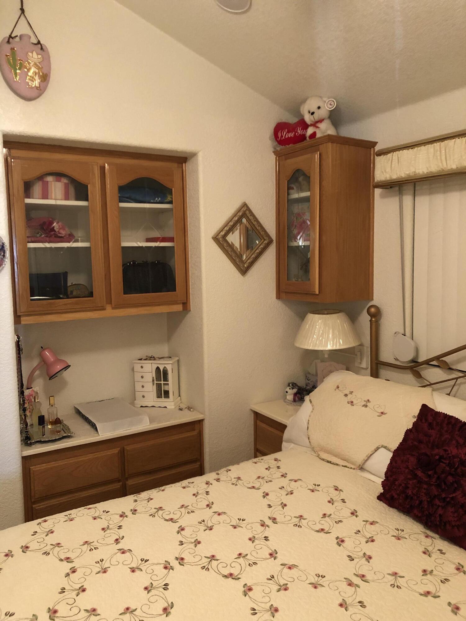 81620 Ave 49, Unit 160B Indio, CA 92201 - Photo 8 of 18 a bedroom with a bed and wooden floor