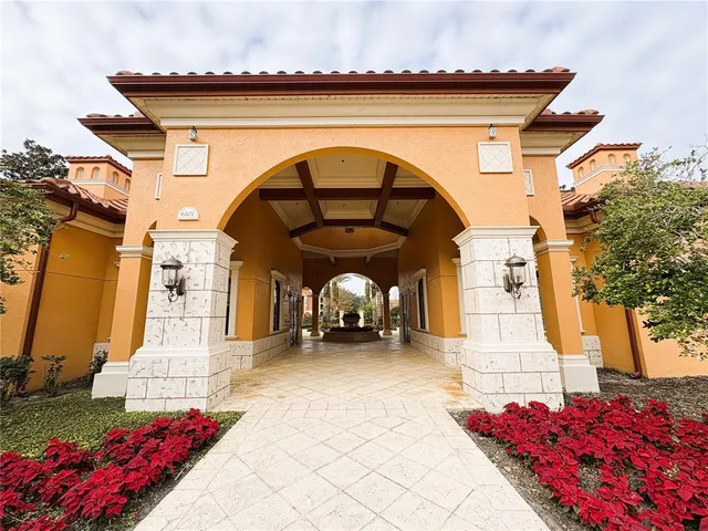 a view of swimming pool with table and chairs under an umbrella