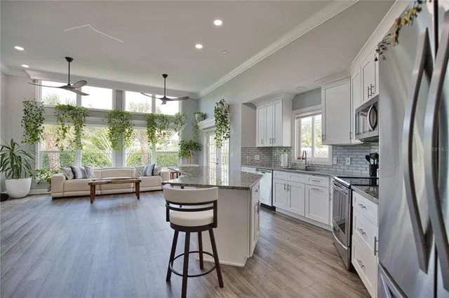 a kitchen with counter top space and wooden floor