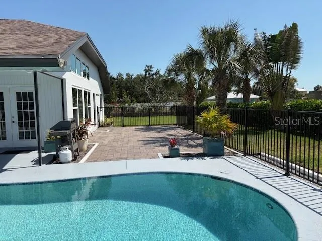 a view of a house with backyard porch and sitting area