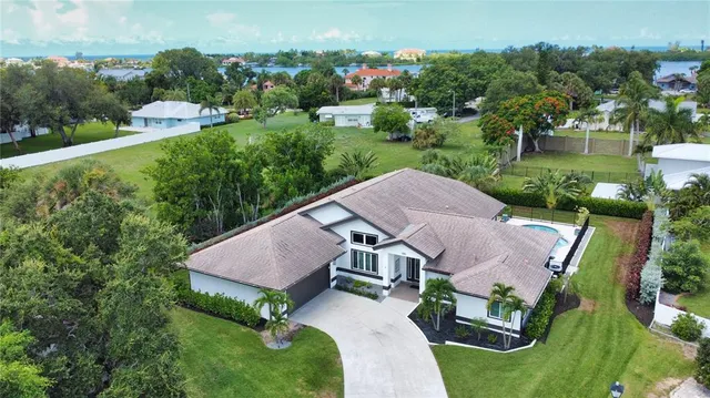 an aerial view of a house with a garden and trees