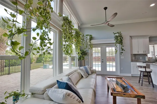 a living room with furniture and a floor to ceiling window