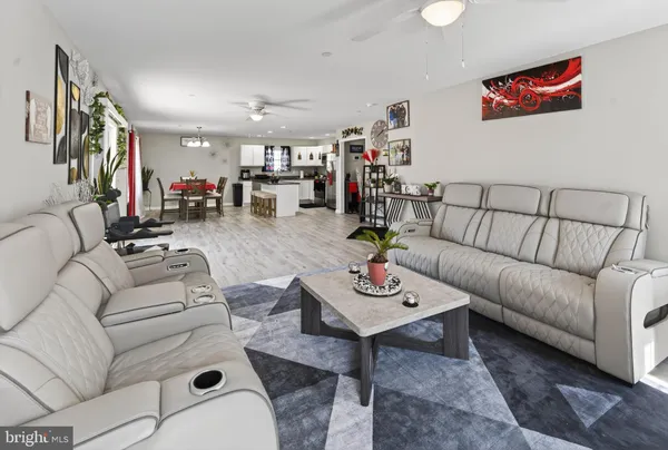 a living room with furniture kitchen view and a table