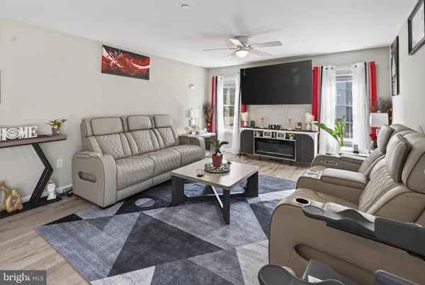 a living room with furniture flat screen tv and a fireplace