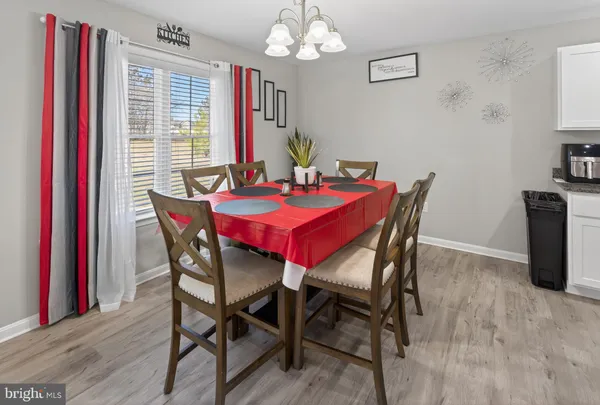 a view of a dining room with furniture and chandelier