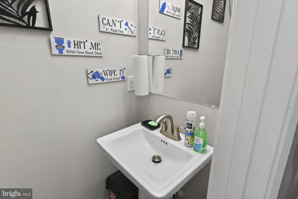 a bathroom with a sink and a refrigerator