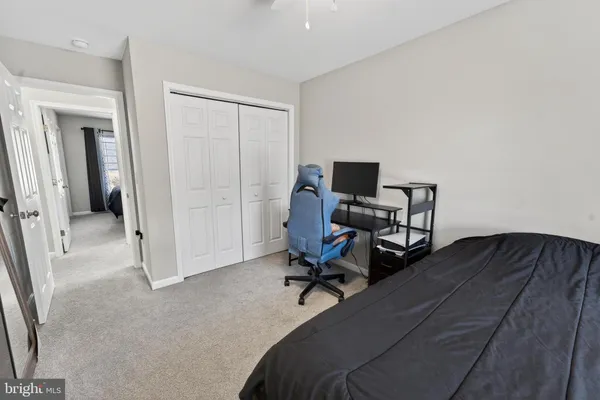 a view of a workspace with furniture and a bedroom