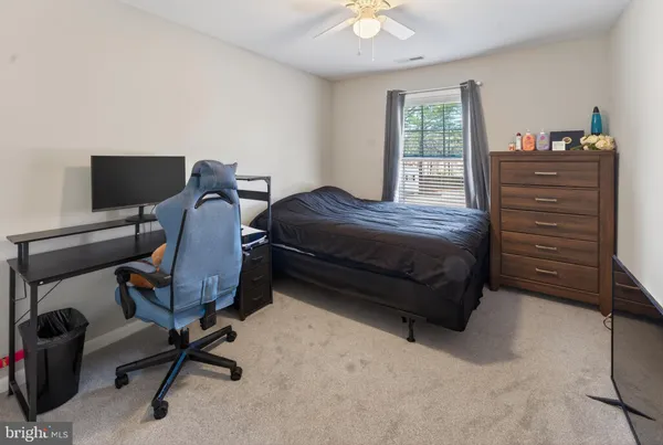 a bedroom with a bed and a desk
