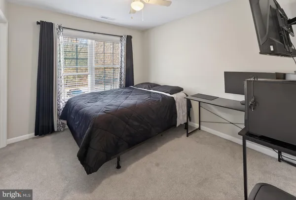 a bed sitting in a room next to a window