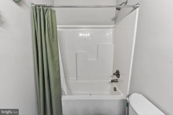a bathroom with a shower and a toilet