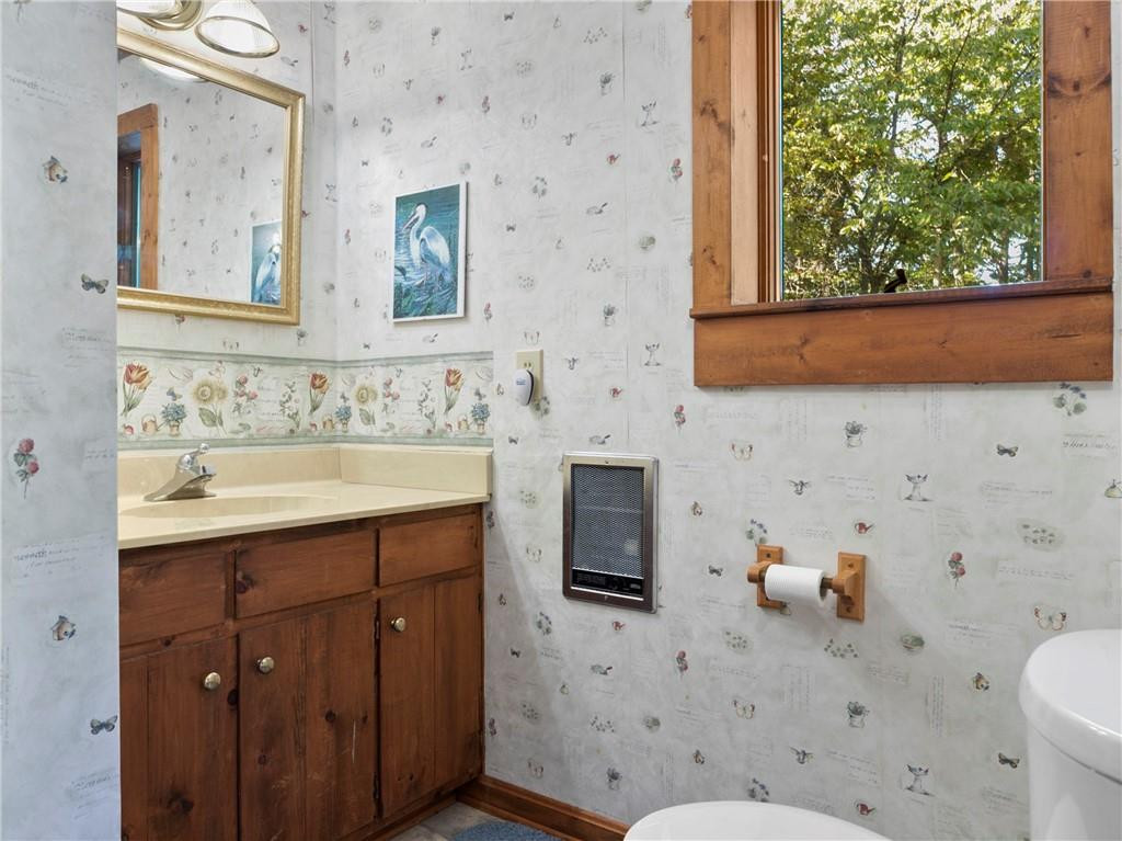 1641 Concord Church Road Roxboro, NC 27574 - Photo 29 of 30 a bathroom with a sink a toilet and mirror