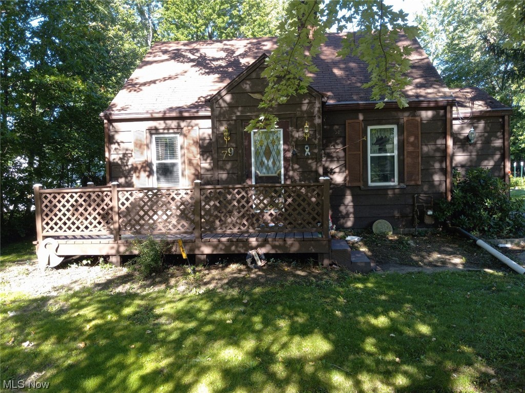 View of side of property with a lawn