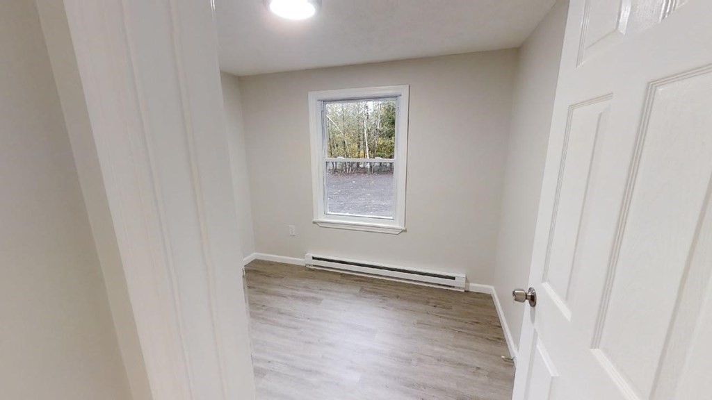 474 Forristall Road Winchendon, MA 01475 - Photo 19 of 29 a view of an empty room with wooden floor and a window
