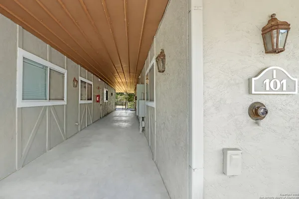 a view of a hallway to a livingroom with furniture