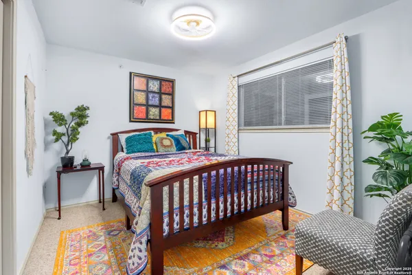 a bedroom with a bed and a potted plant