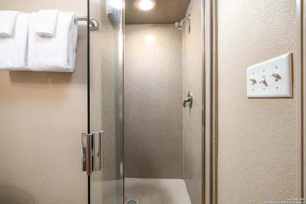a bathroom with a shower and a glass door