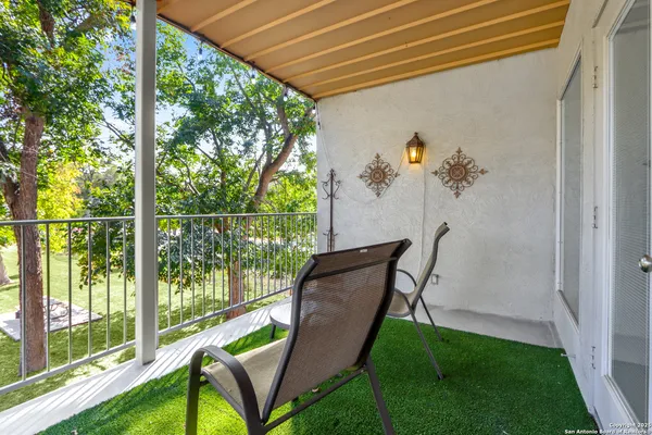 a view of porch with a table and chairs