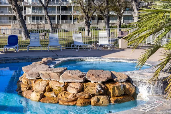 a view of swimming pool with outdoor seating