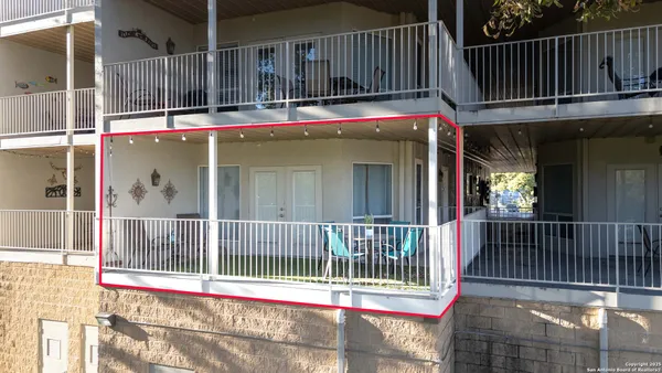 a view of a house with a small deck