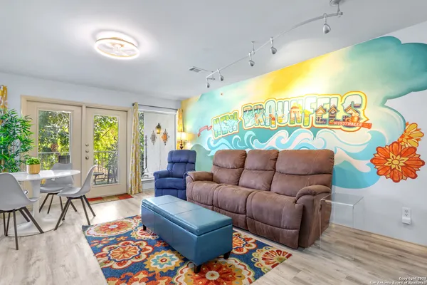 a living room with furniture and a large window