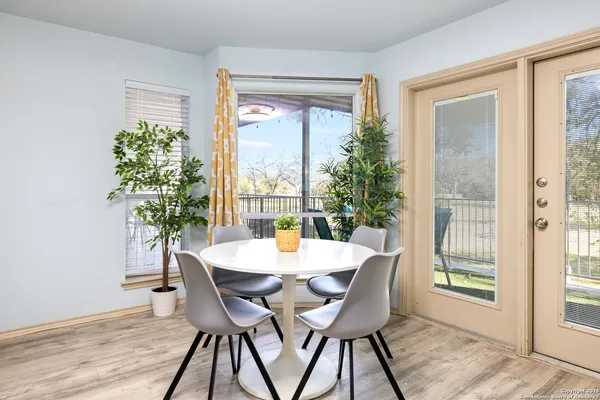 a dining room with furniture window and wooden floor
