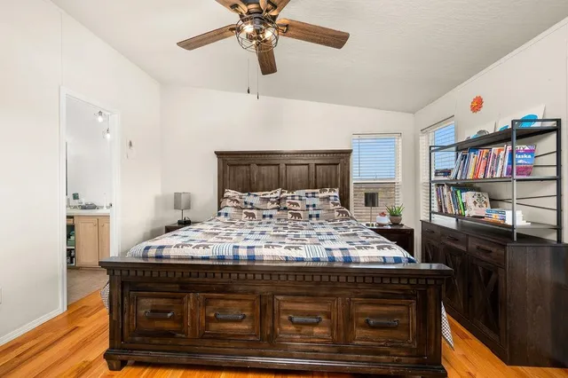 a bed sitting in a bedroom next to a bookshelf