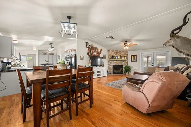 a living room with furniture a fireplace and kitchen view