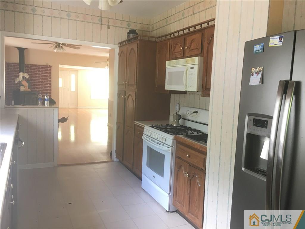 2 Matawan Road Old Bridge, NJ 08879 - Photo 12 of 15 a kitchen with stainless steel appliances granite countertop a refrigerator and a stove