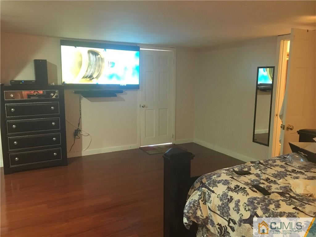 2 Matawan Road Old Bridge, NJ 08879 - Photo 4 of 15 a bedroom with a bed and a flat tv screen on dresser