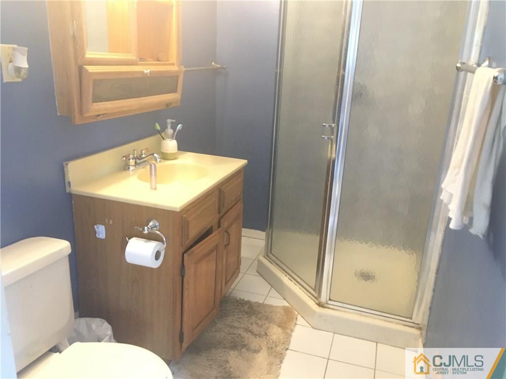 2 Matawan Road Old Bridge, NJ 08879 - Photo 5 of 15 a bathroom with a sink a toilet a mirror and shower