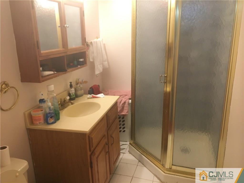 2 Matawan Road Old Bridge, NJ 08879 - Photo 7 of 15 a bathroom with a sink and a mirror
